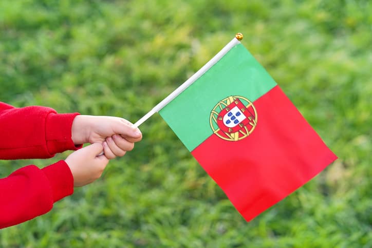 Little girl holding Portugal’s flag