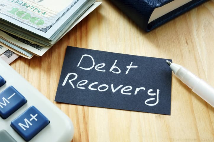 A chalk board that says Debt Recovery