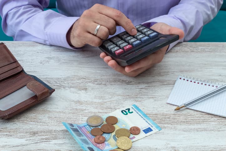 Young man calculates family accounts with the calculator