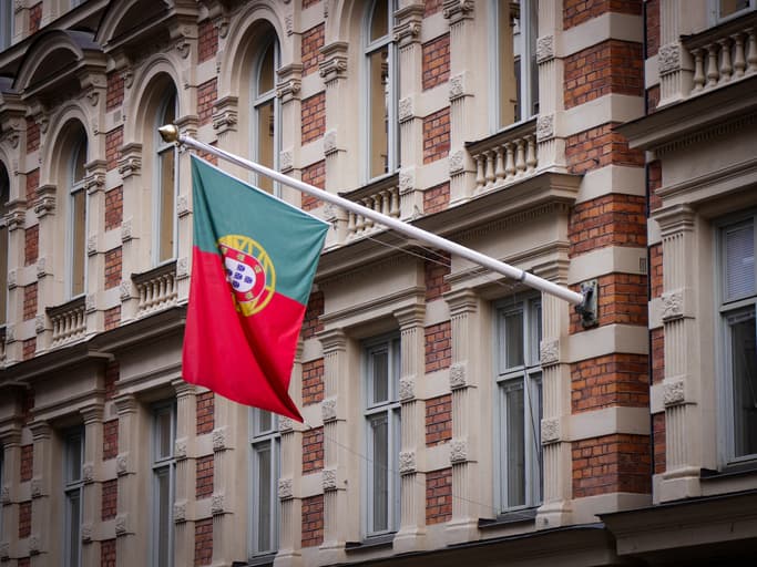 A flag on the side of a building in Portugal